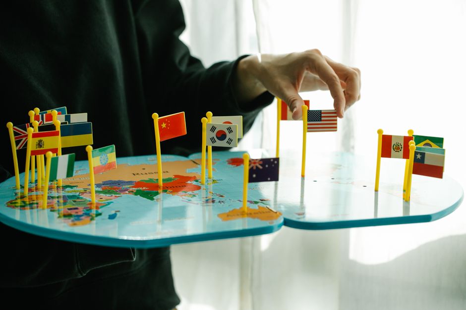 image of a person looking at a world map with flags of the USA and another country (e.g., Mexico) pinned on it - dual citizenship lawyer near me image of a person looking at a world map with flags of the USA and another country (e.g., Mexico) pinned on it - dual citizenship lawyer near me