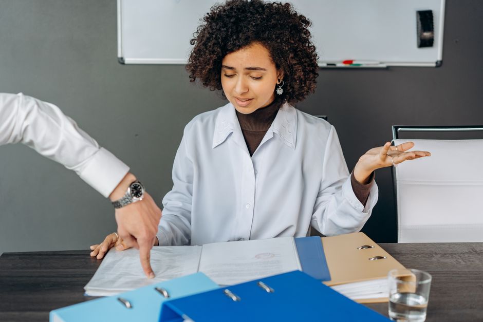 image of a person looking stressed while sorting through a large pile of official-looking documents and forms - dual citizenship lawyer near me image of a person looking stressed while sorting through a large pile of official-looking documents and forms - dual citizenship lawyer near me