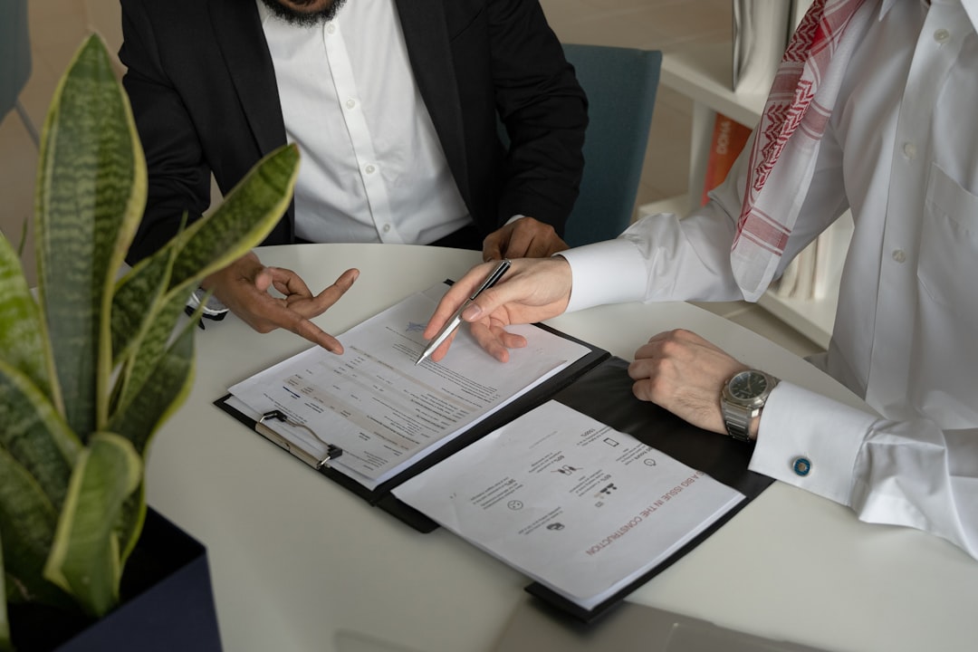 lawyer and client reviewing documents together in an office - Experienced immigration lawyer
