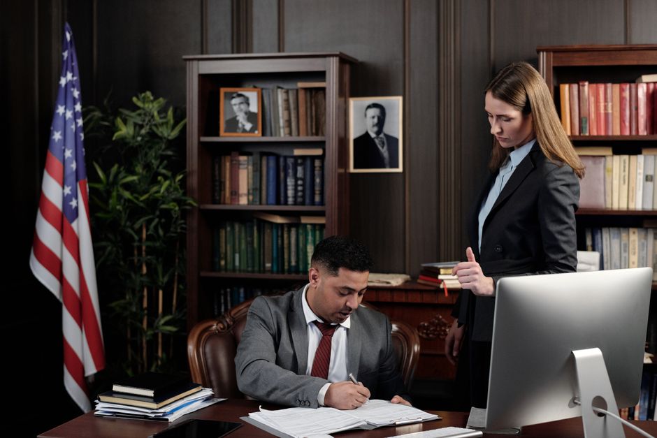 A legal professional reviewing compliance documents in a professional office setting