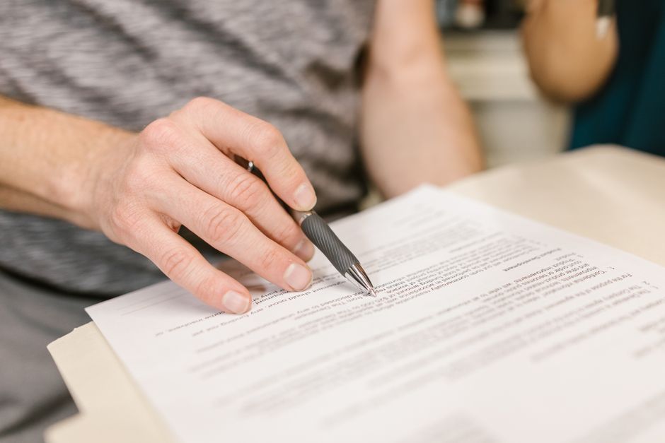 A person diligently filling out an official government form, emphasizing the detailed nature of the application process. - Humanitarian parole lawyer A person diligently filling out an official government form, emphasizing the detailed nature of the application process. - Humanitarian parole lawyer