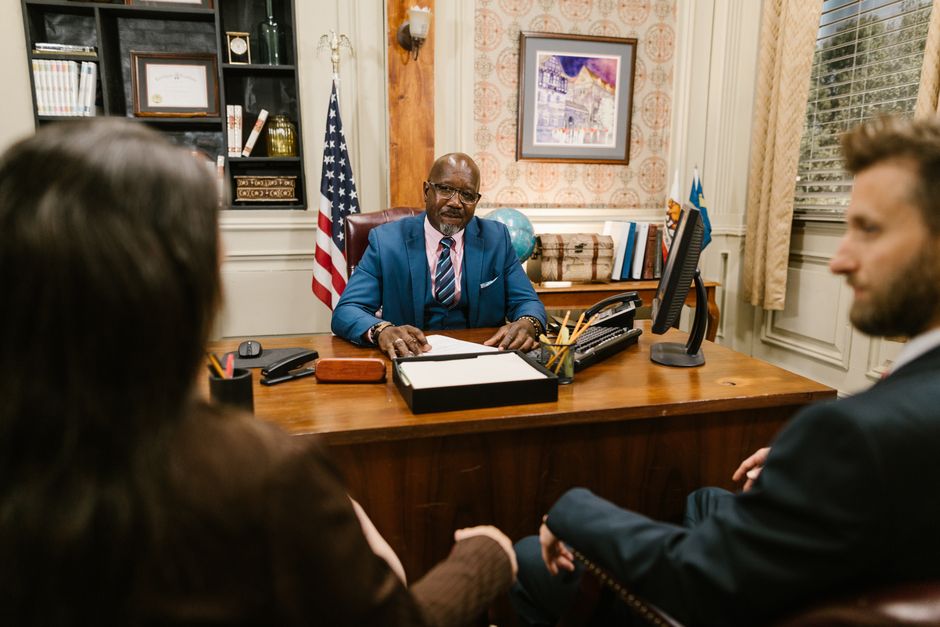 A lawyer consulting with a client over documents, illustrating personalized legal guidance. - immigration lawyer for work visas A lawyer consulting with a client over documents, illustrating personalized legal guidance. - immigration lawyer for work visas