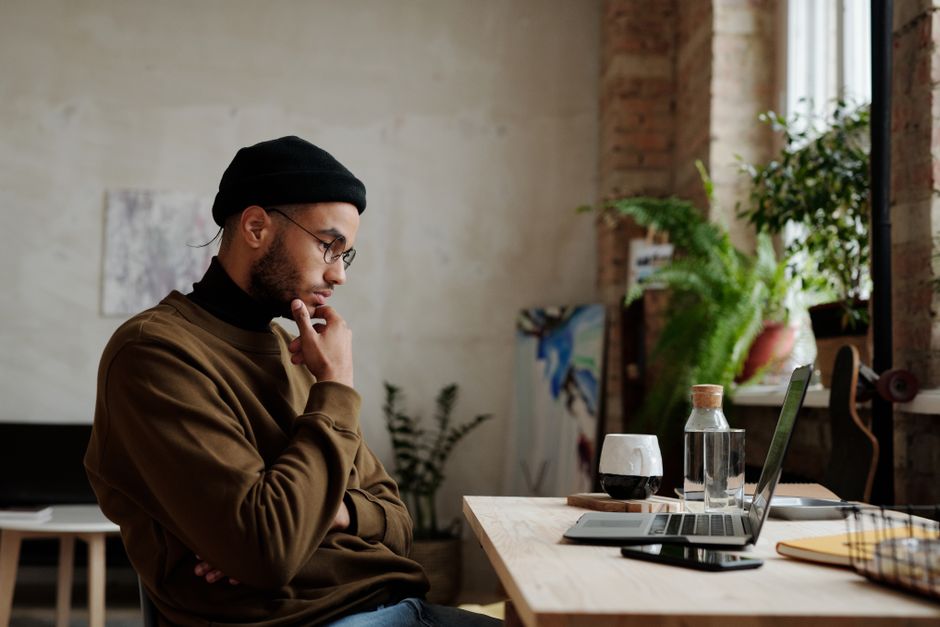 A person looking thoughtfully at a laptop screen, contemplating immigration options. - immigration lawyer for work visas A person looking thoughtfully at a laptop screen, contemplating immigration options. - immigration lawyer for work visas